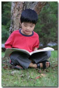 young boy reading a non-ficton text